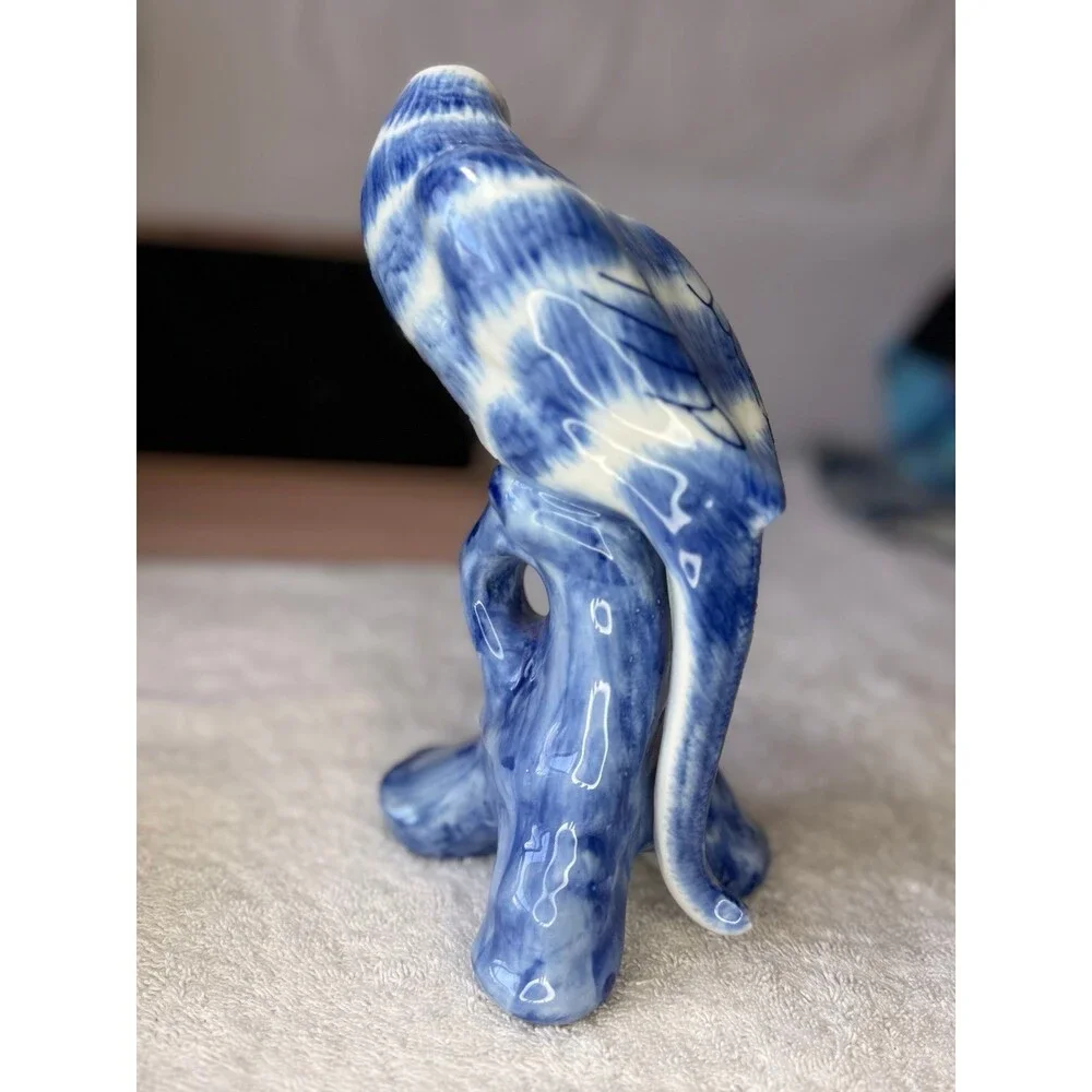 Chinoiserie blue and white porcelain parrot figurine, likely hand-painted.